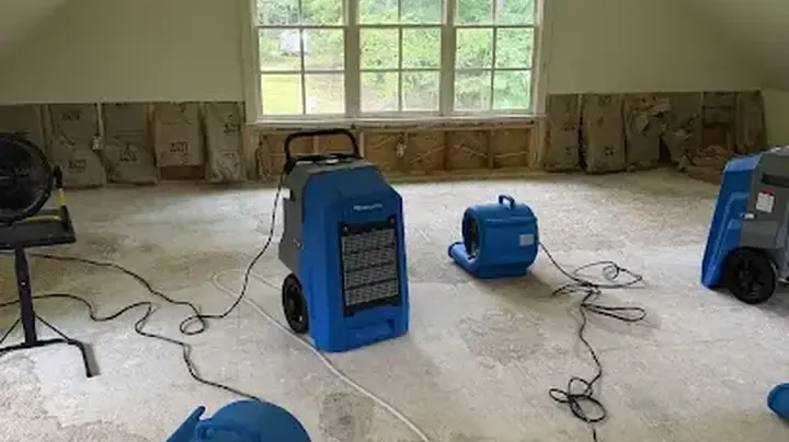 Air movers and a dehumidifier set up to dry a bonus room