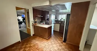 Opening cut in a kitchen ceiling so the wet space above can be dried