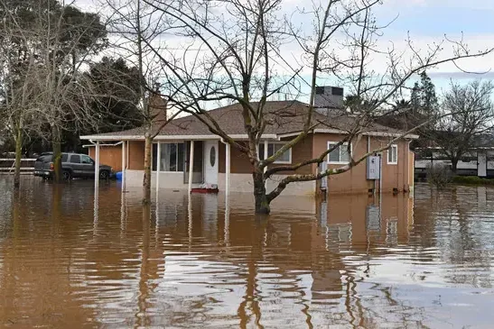 Ranch home surrounded by storm flood water